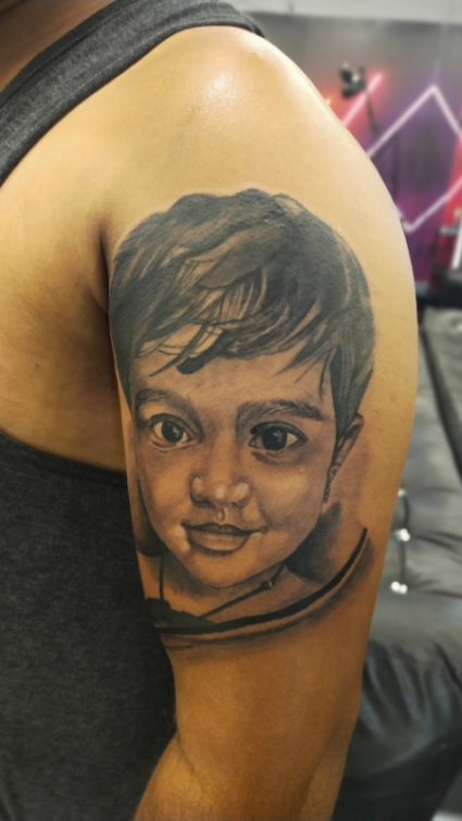 Realistic tattoo designs for men on arm by Inkaura Tattoos in Pune.