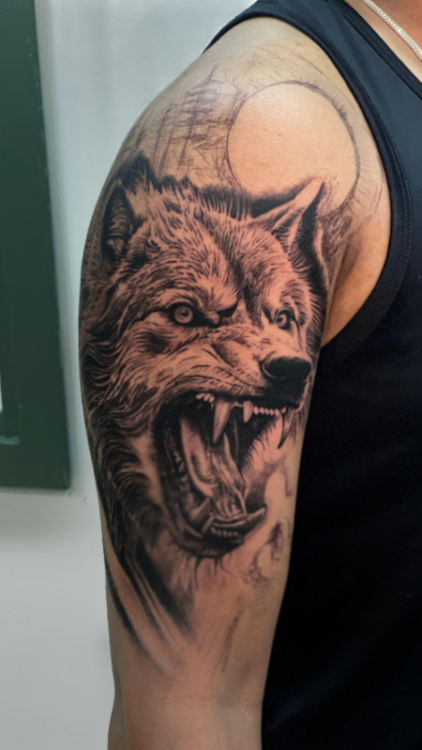 Animal tattoo designs for men on upper arm by Inkaura Tattoos in Pune.