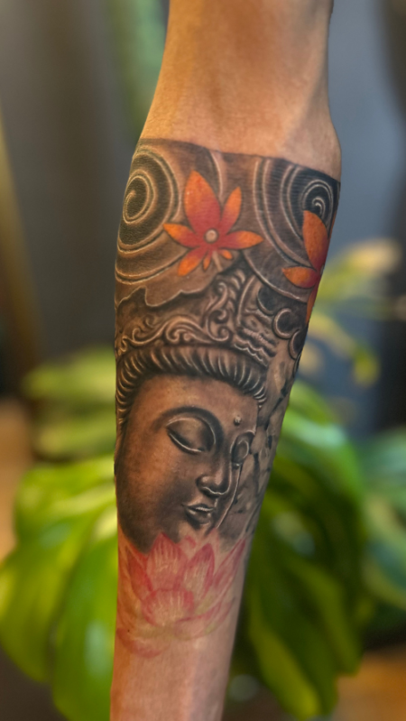 Buddha forearm tattoo by Inkaura Tattoos, the best tattoo shop in Pune.