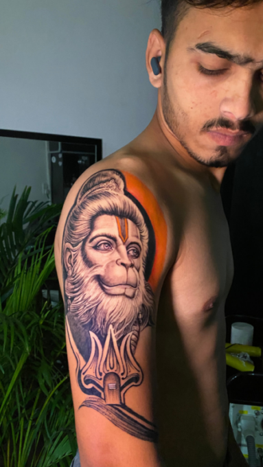 Hanuman tattoo designs for men on upper arm by Inkaura Tattoos in Pune.