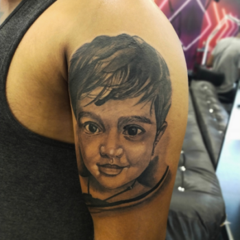 Realistic tattoo designs for men on arm by Inkaura Tattoos in Pune.